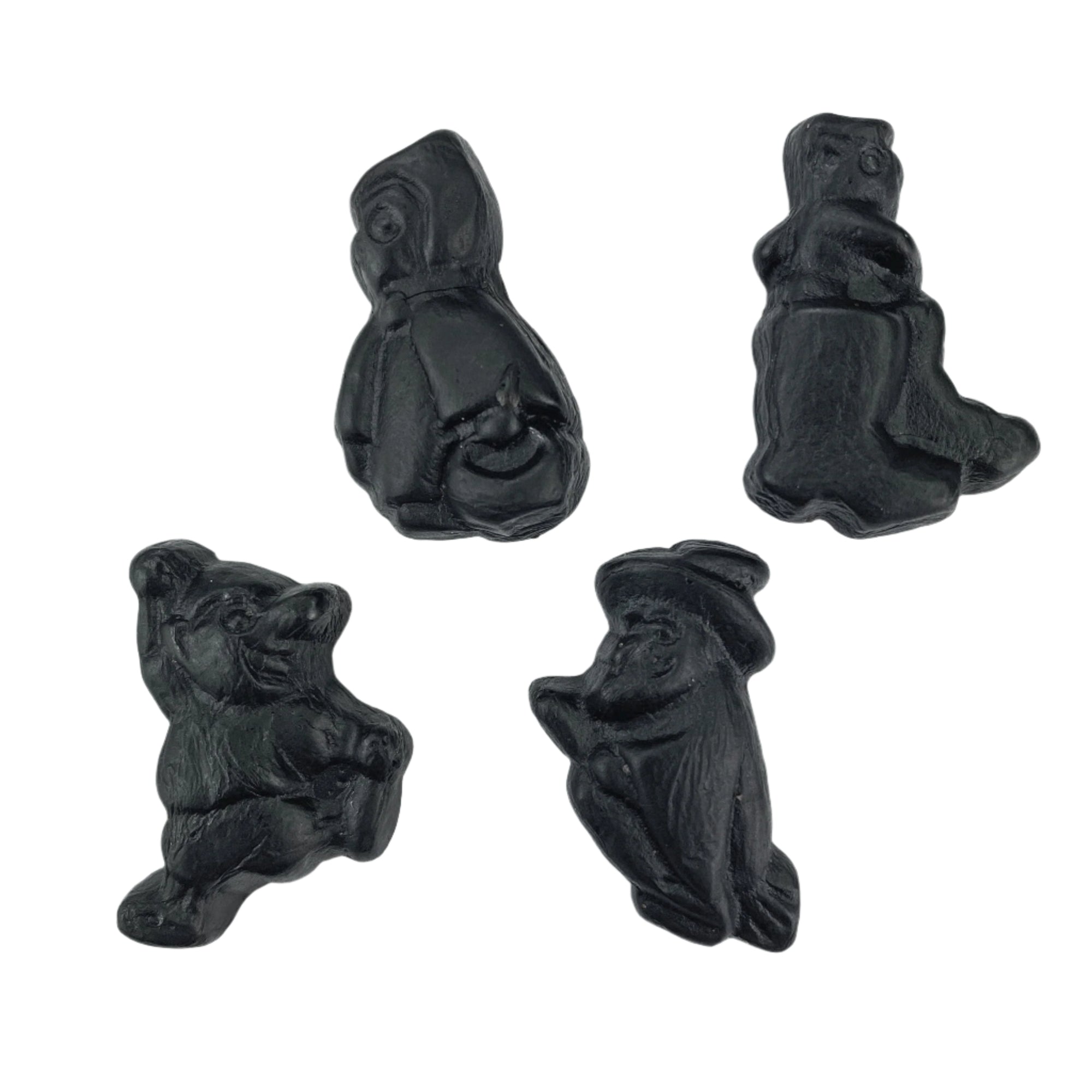 A collection of black licorice candies in shapes of various characters, resembling fairy tale creatures.